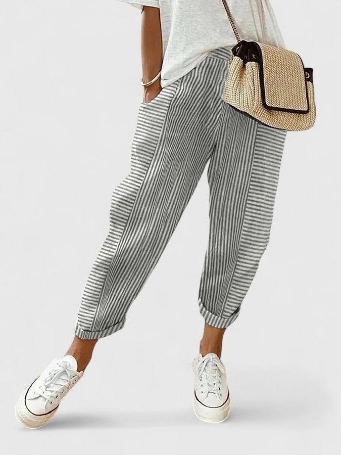 Light gray striped relaxed pants with elastic cuffs and pleated drape.
