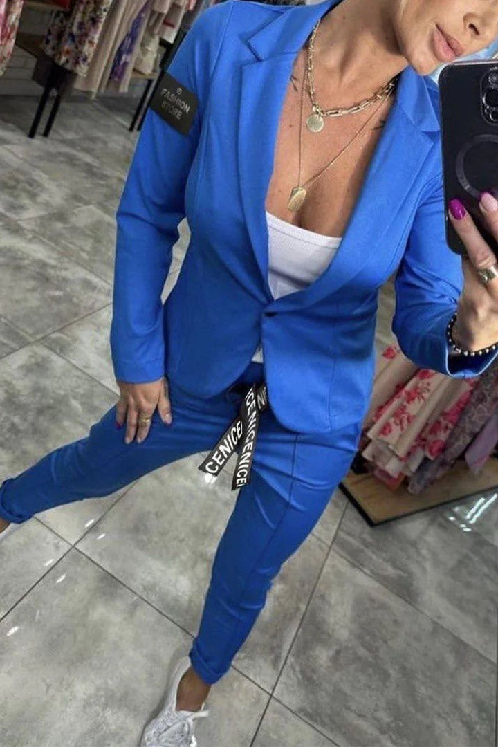 Blue casual blazer and matching trousers set, open front over white tank
