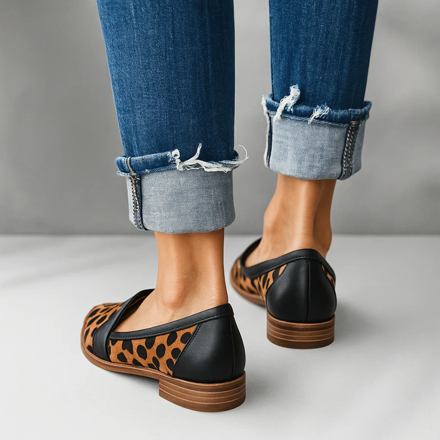 Black classic slip-on flats with leopard side panels, wide strap, low wooden sole