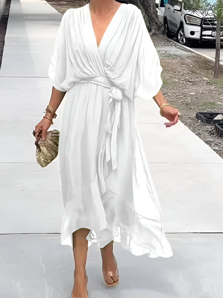 White chiffon V-neck dress with gathered waist tie and draped mid-calf skirt