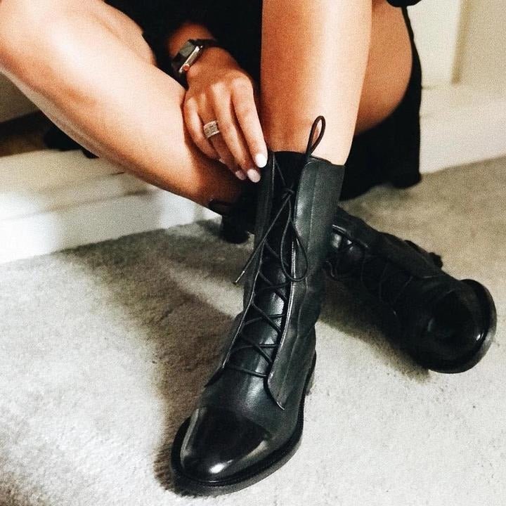 Black lace-up ankle boots with round toe, lace-up front, and low block heel.