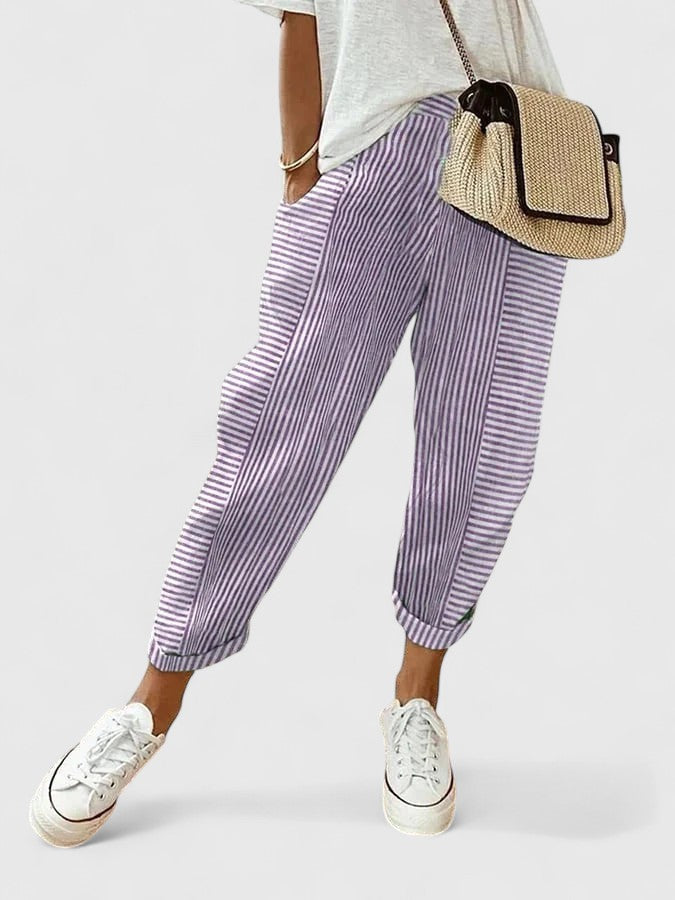 Purple striped relaxed pants with elastic cuffs and pleated drape.