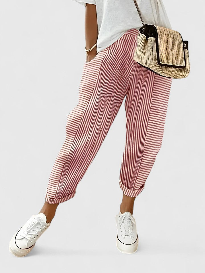 Light red striped relaxed pants with elastic cuffs and pleated drape.