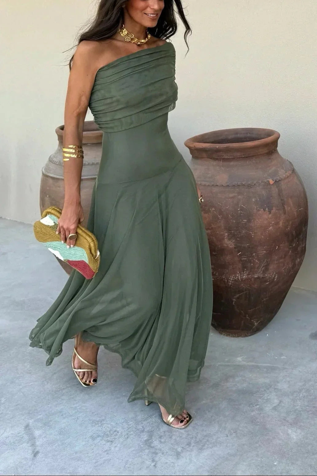 Dark green one-shoulder pleated maxi dress with draped bodice and flowing skirt