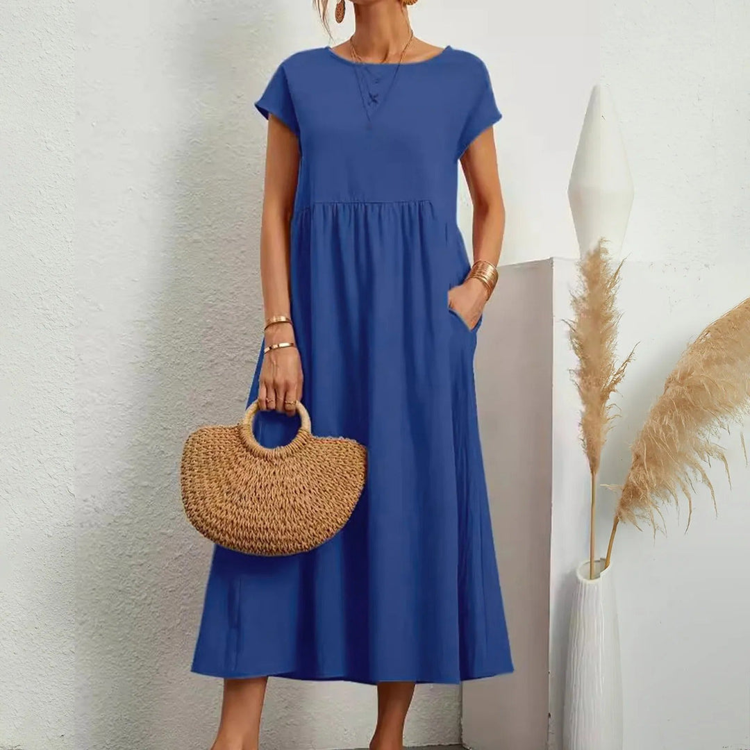 Blue midi dress with short sleeves, round neck, and gathered waist with a flowy skirt.