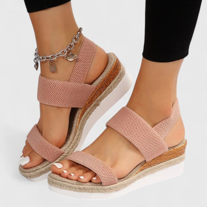 Women’s orthopedic sandals with arch support, blush crisscross straps and gold ankle chain.