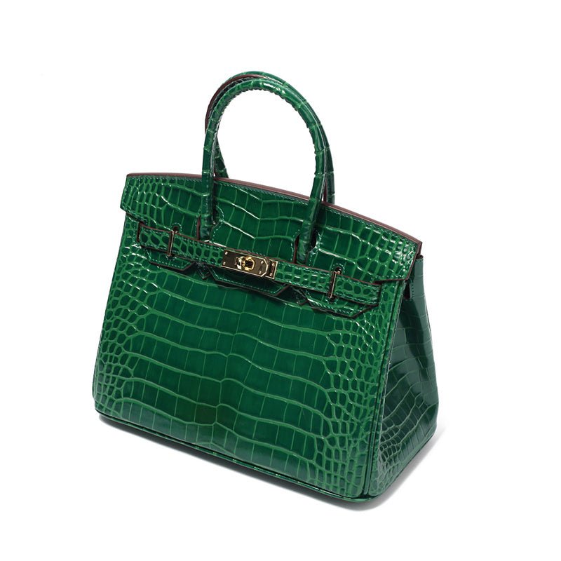Green crocodile-textured leather handbag with top handles and gold-tone front clasp.