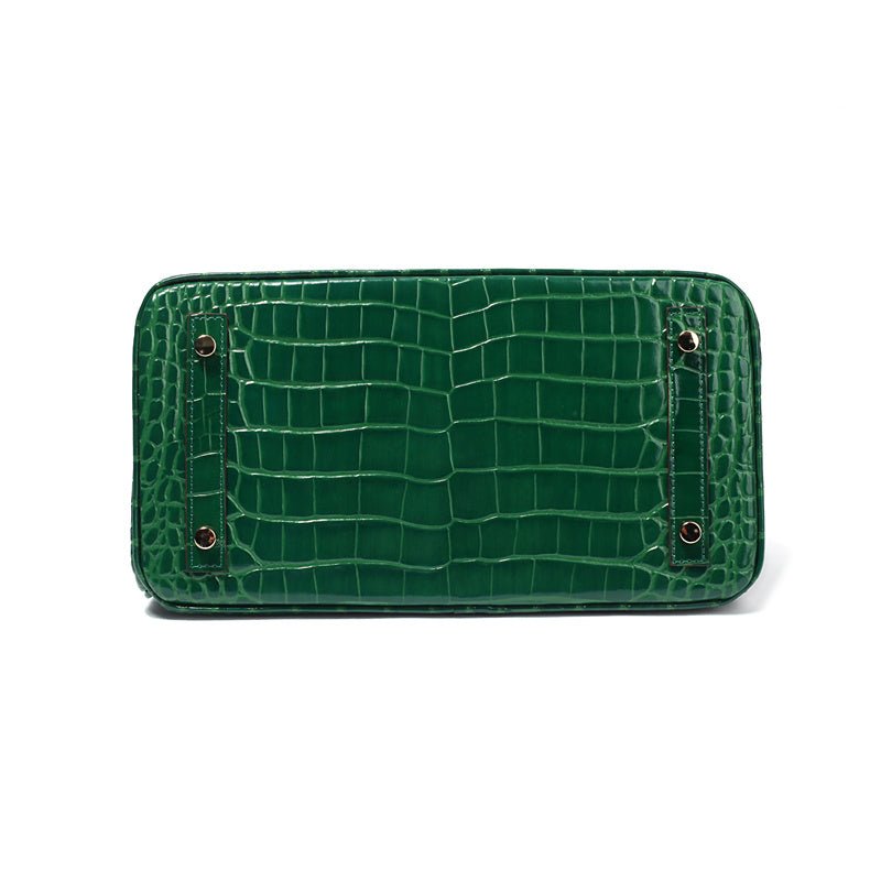Green croc-embossed mini flap handbag with two snap buttons.