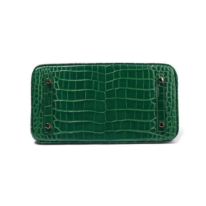 Green croc-embossed mini flap handbag with two snap buttons.
