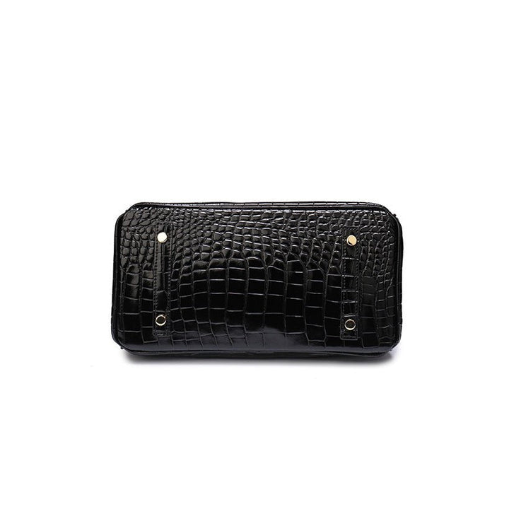 Black crocodile-textured clutch with snap closure and gold-tone hardware