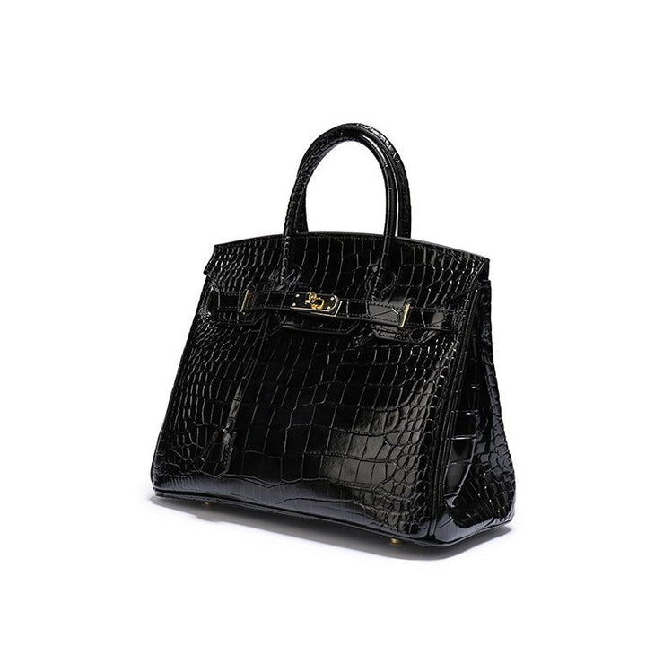 Black croc-textured tote handbag with top handles and gold-tone front clasp