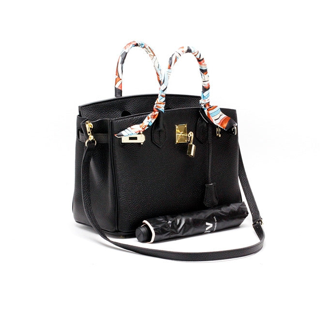 Black handbag with scarf-tie handles and gold front lock