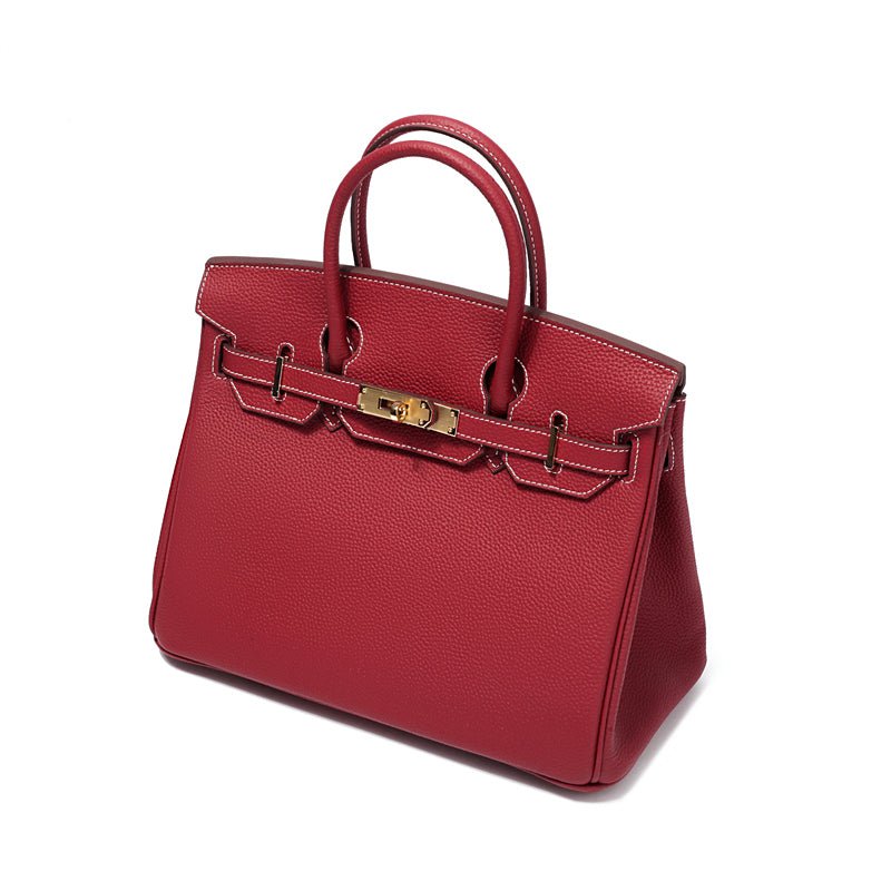 Wine red leather handbag with top handles, front clasp strap, and gold-tone hardware.