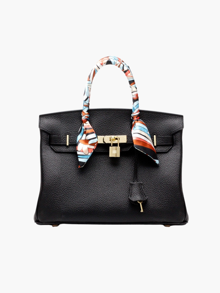 Women’s structured handbag in black with top handles and patterned scarf ties