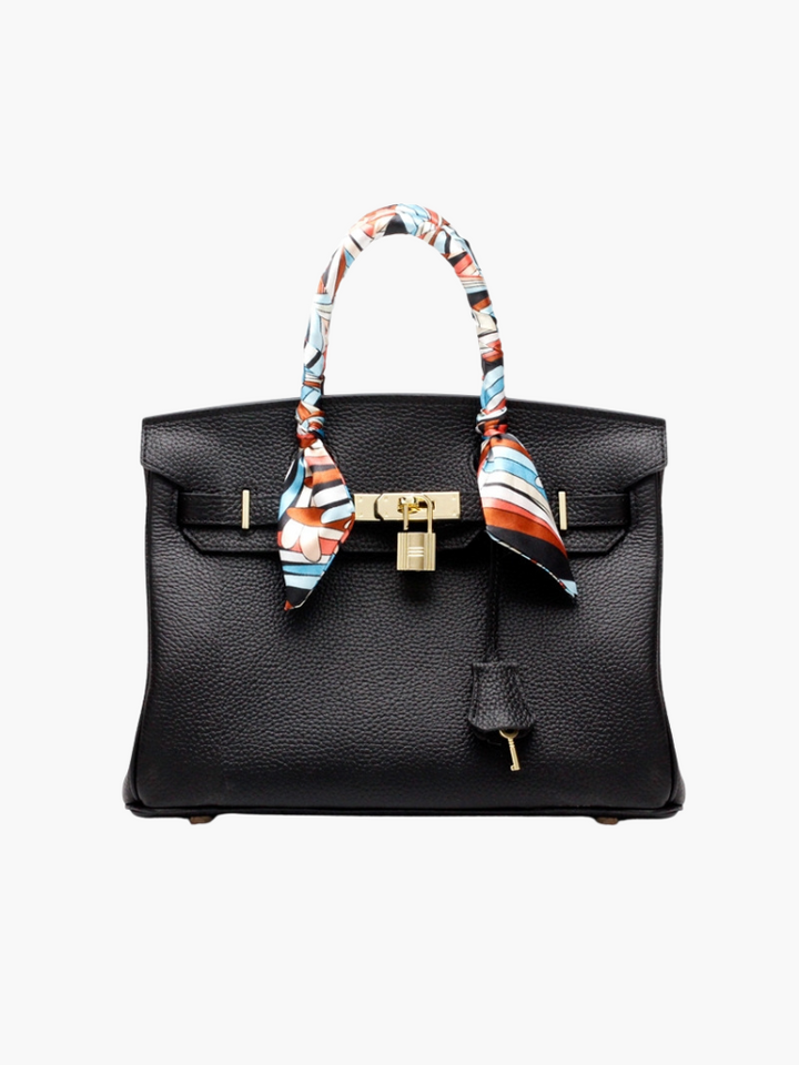 Women’s structured handbag in black with top handles and patterned scarf ties