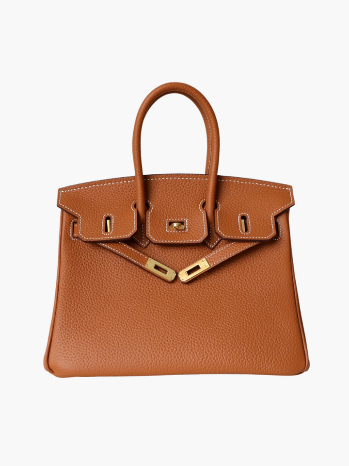 Women’s structured handbag in tan with top handles and gold-tone front clasp