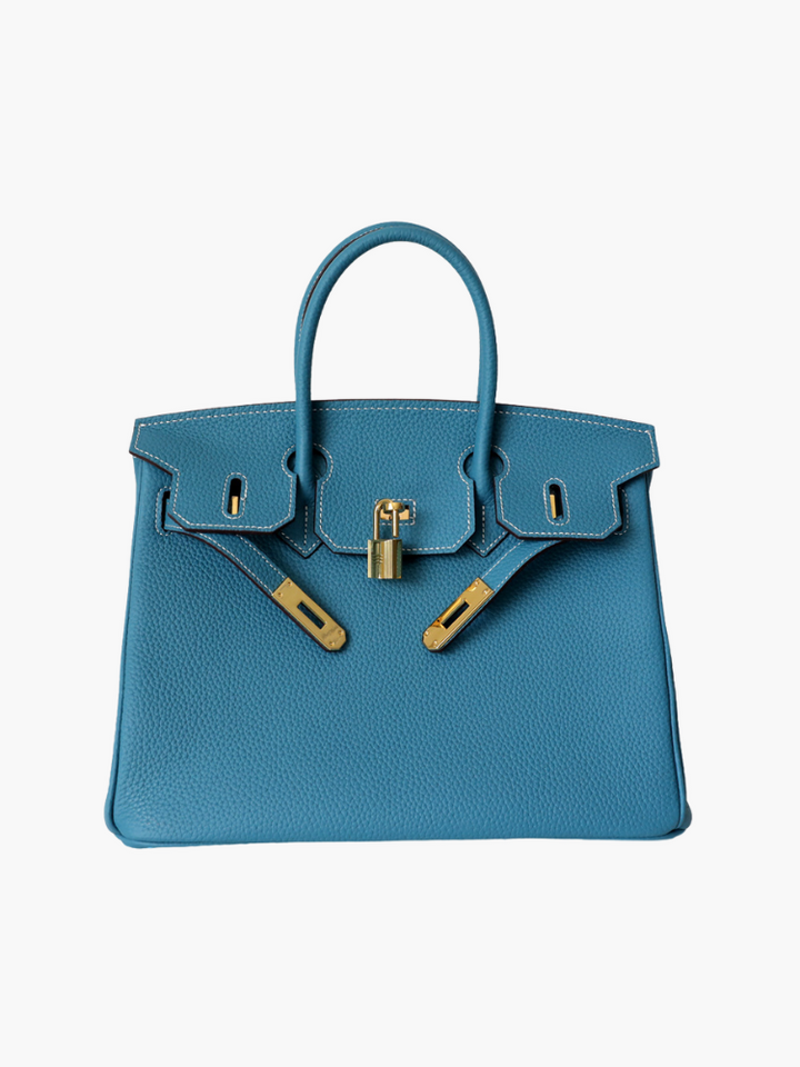 Blue pebbled handbag with gold front clasp and top handles.