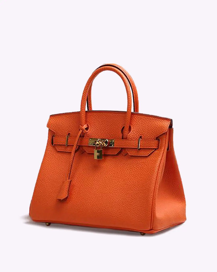 Orange leather handbag with top handles, front flap detail, and gold-tone lock hardware.