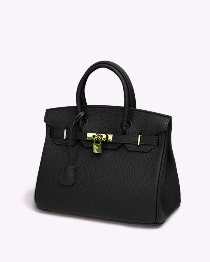 Black leather handbag with top handles, front flap clasp, and gold-tone lock hardware.