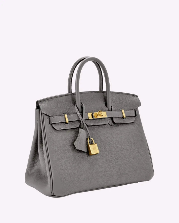 Grey leather handbag with top handles, front flap clasp, and gold-tone lock hardware.