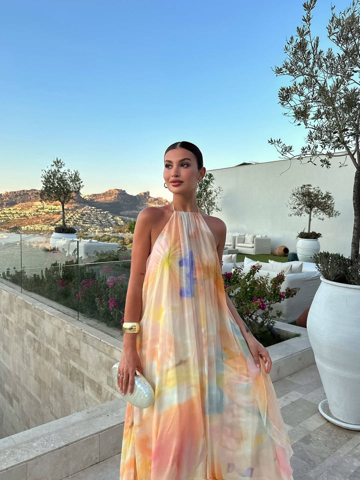 Orange printed halter maxi dress with V halter neckline and pastel swirl pattern