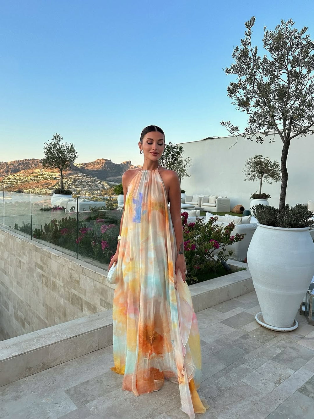 Orange printed halter maxi dress, sleeveless halter neck and long flowing skirt