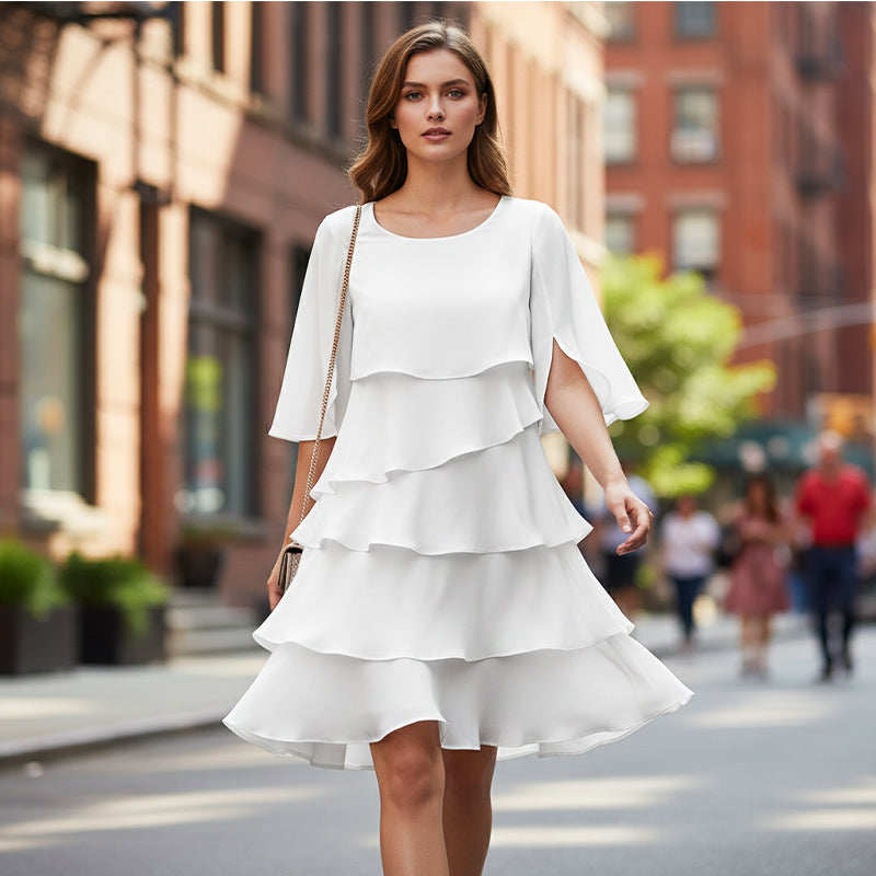 Women’s white tiered dress with flutter sleeves and layered ruffle skirt