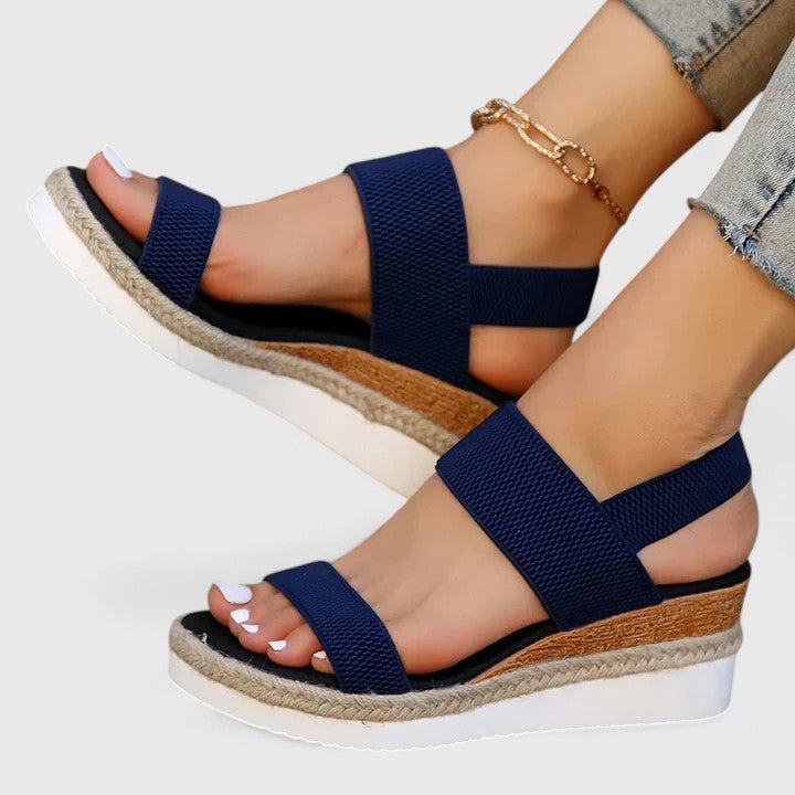 Women’s orthopedic sandals with arch support, navy woven straps and espadrille-style wedge sole.