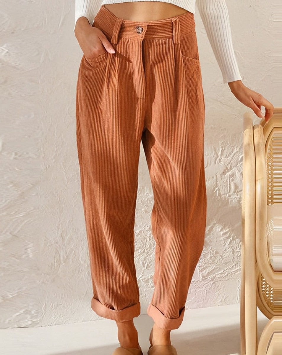 Relaxed corduroy pants in orange with button front, vertical cord texture, and cuffed hems